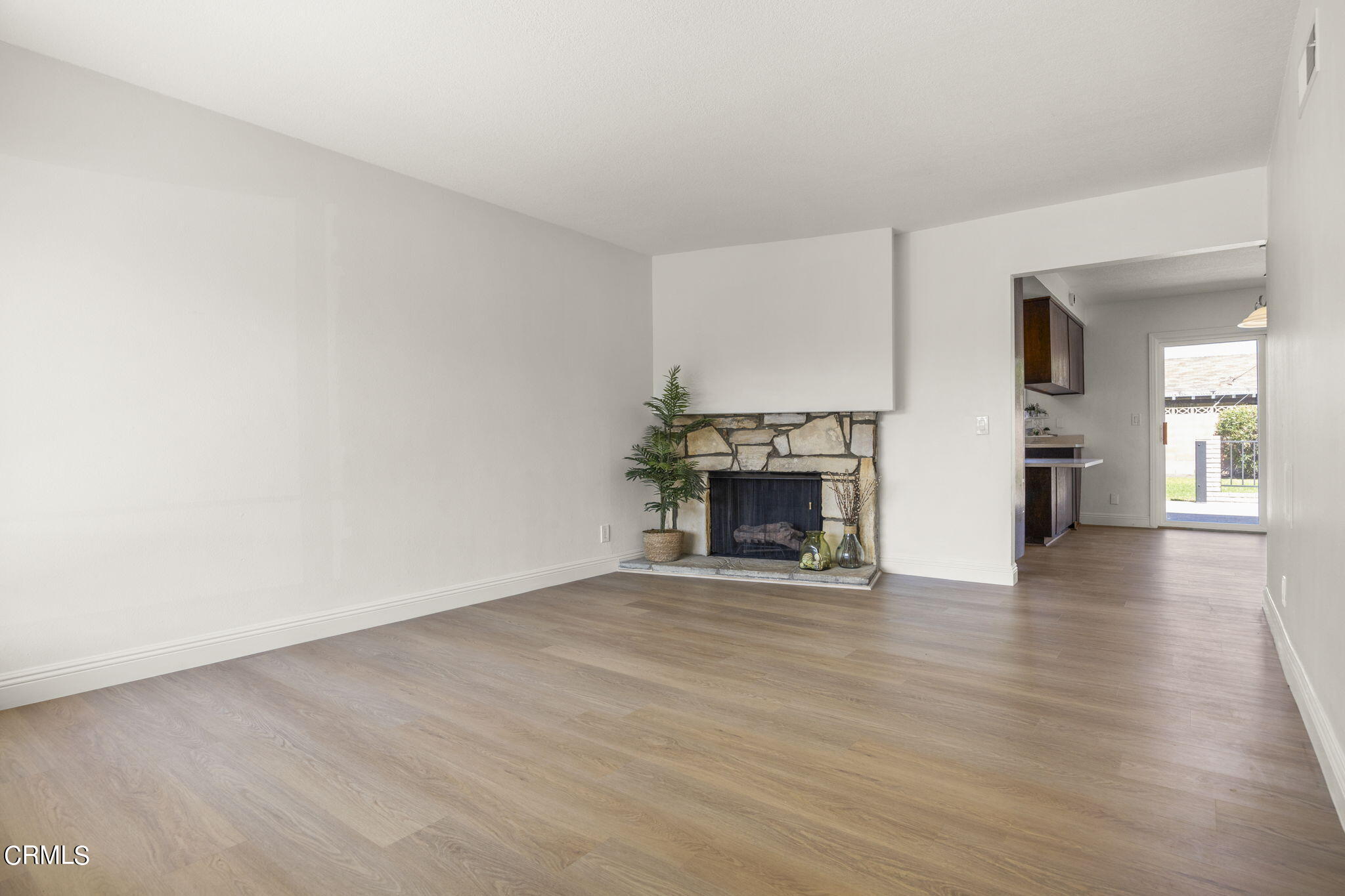 1225 Azalea Street Oxnard, CA 93036 - Photo 4 of 41 a view of an empty room with wooden floor fireplace and a window