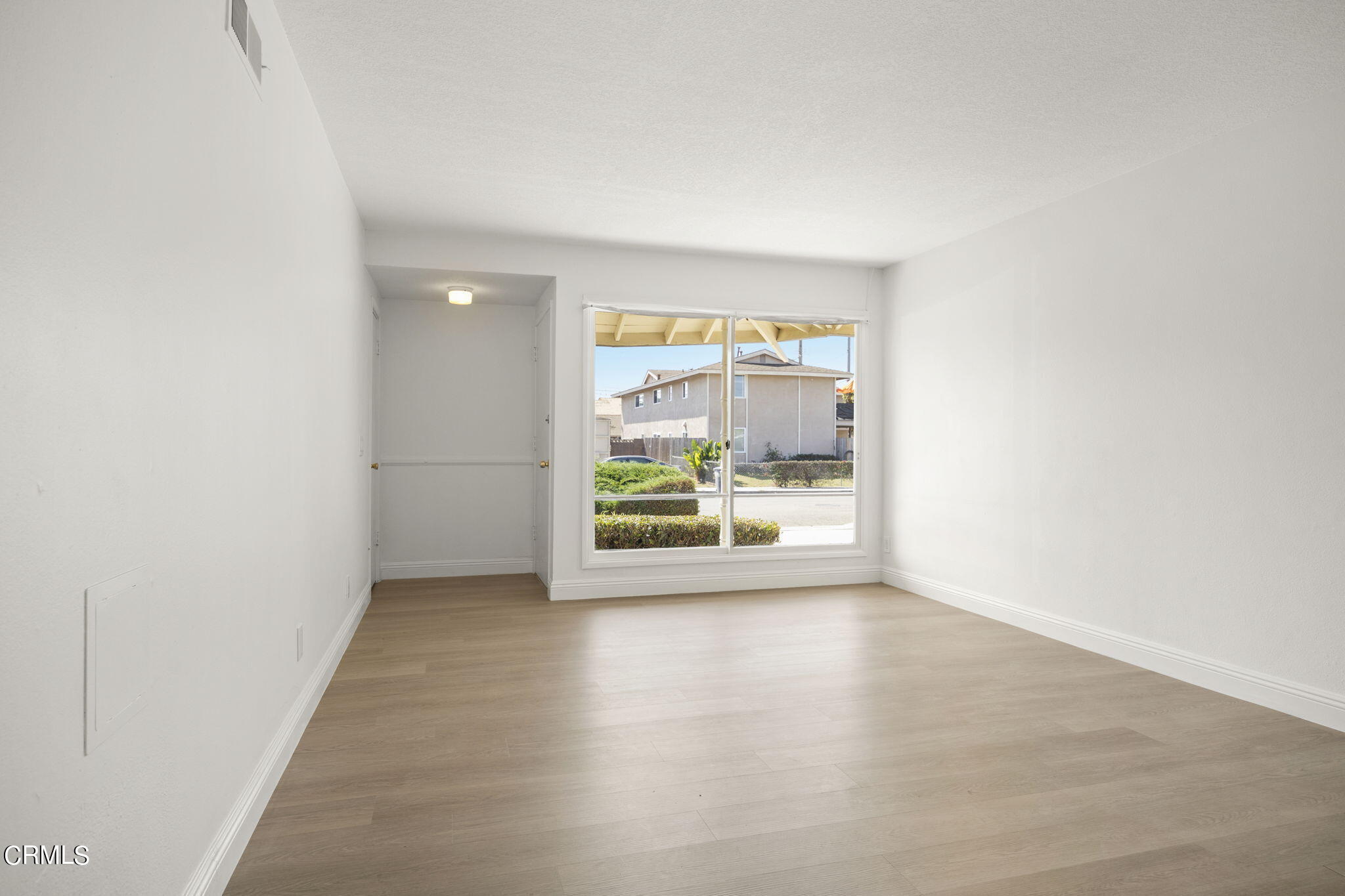 1225 Azalea Street Oxnard, CA 93036 - Photo 6 of 41 a view of a big room with wooden floor and windows