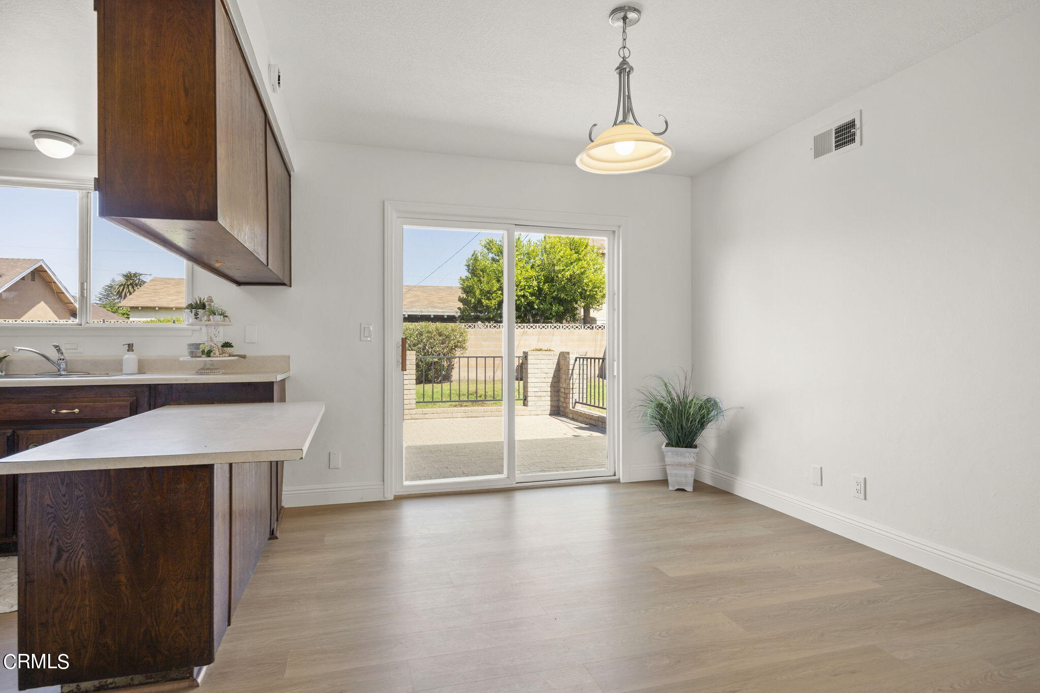 1225 Azalea Street Oxnard, CA 93036 - Photo 7 of 41 a view of an empty room with a window and wooden floor