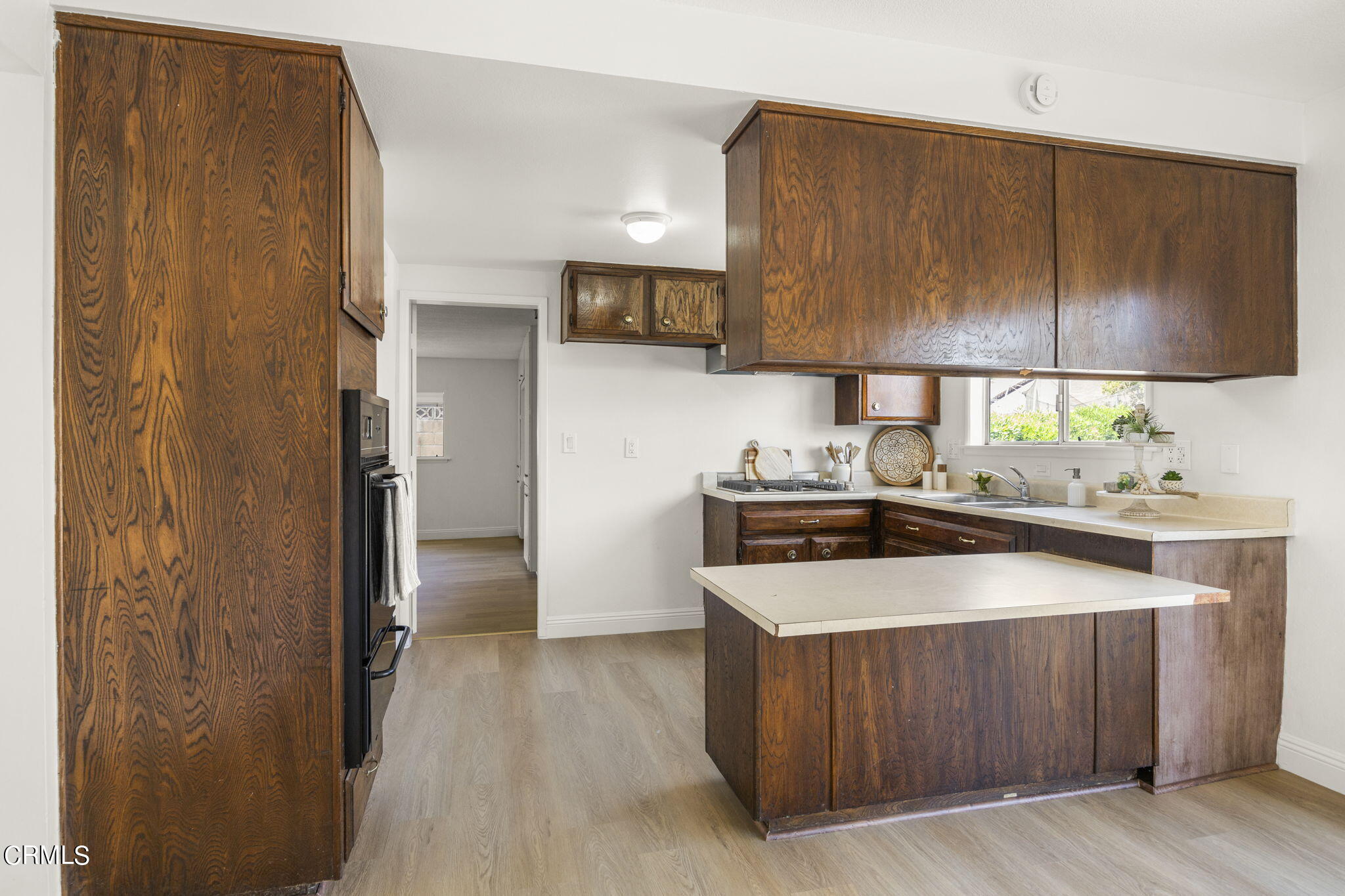1225 Azalea Street Oxnard, CA 93036 - Photo 9 of 41 a kitchen with stainless steel appliances a stove and a refrigerator