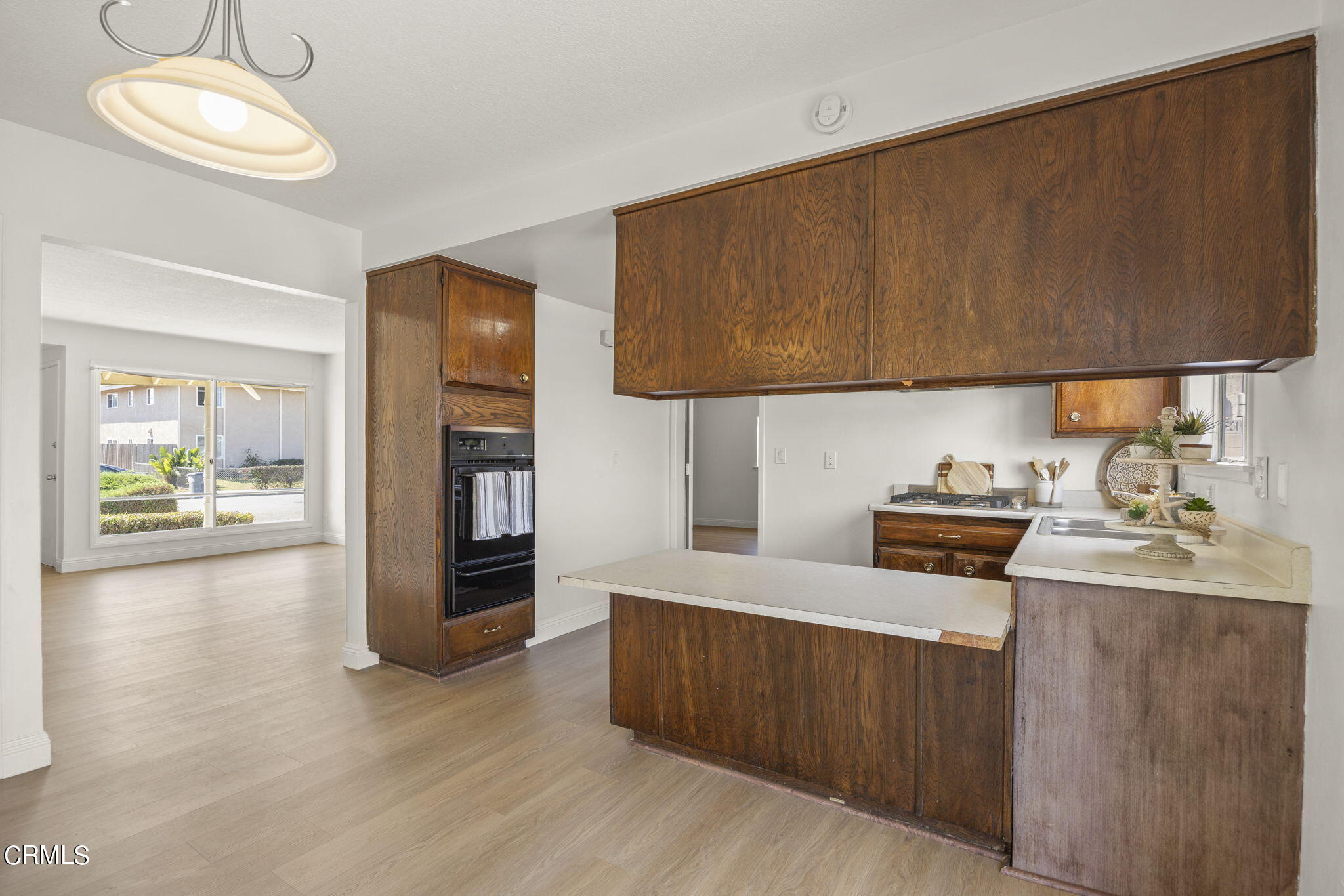 1225 Azalea Street Oxnard, CA 93036 - Photo 10 of 41 a kitchen with stainless steel appliances wooden cabinets a stove top oven a sink and dishwasher