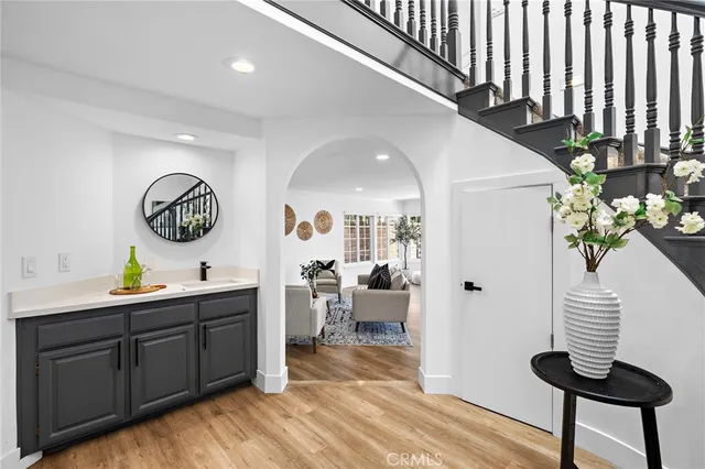 a view of a hallway to a livingroom with furniture and a window