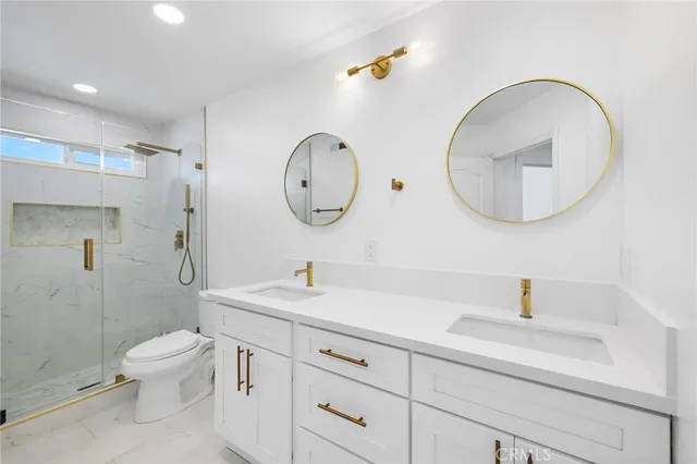 a bathroom with a toilet a sink and mirror