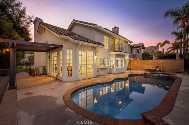 a view of a house with pool and sitting area