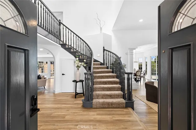 a view of staircase with lots of frames and frames on wall