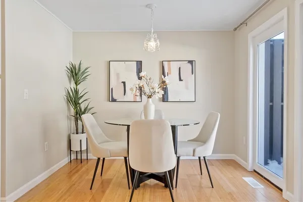 a view of a dining room with furniture and wooden floor