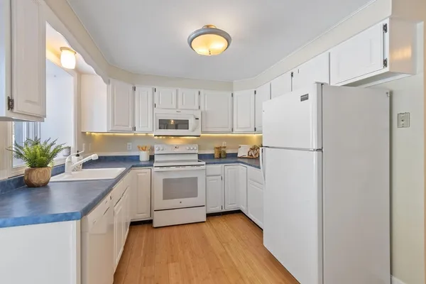 a kitchen with cabinets and stainless steel appliances