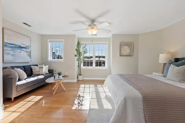 a spacious bedroom with a bed and a lamp