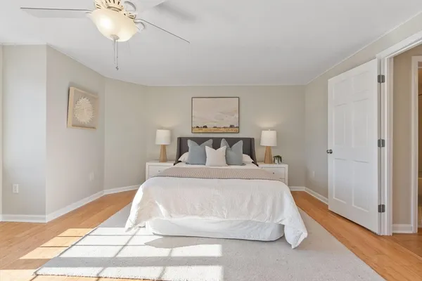 a bedroom with a large bed and a chandelier