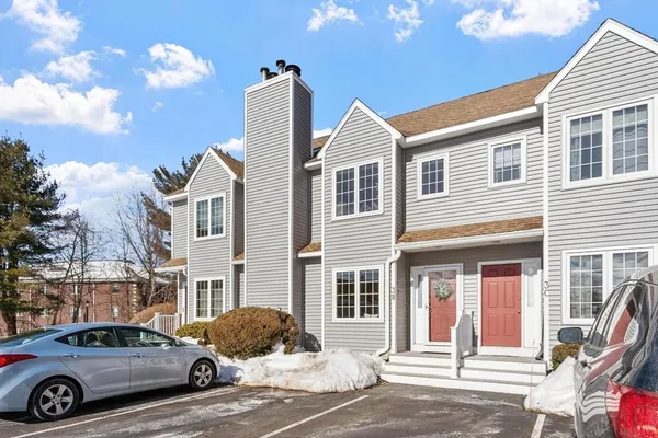 a front view of a house with parking space