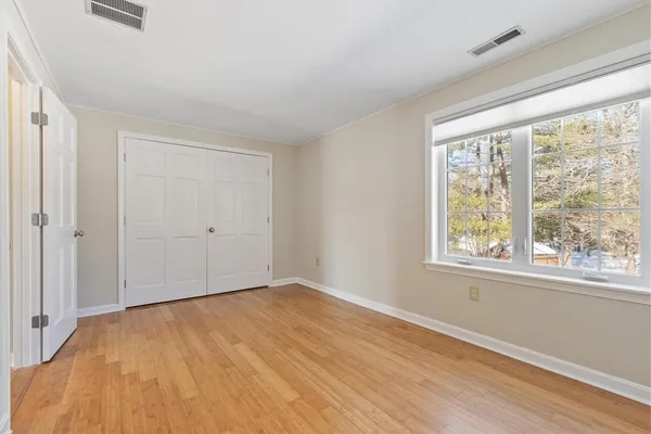 a bathroom with a granite countertop sink toilet and mirror
