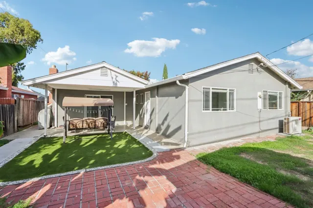 a view of a house with a yard and sitting area