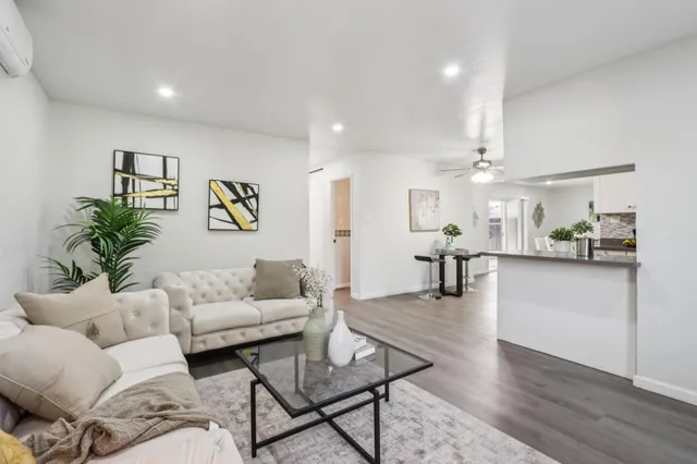 a living room with furniture and wooden floor