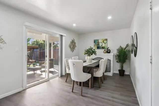 a dining room with furniture window and wooden floor
