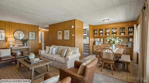 a living room with furniture a rug and wooden floor