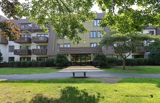 a swimming pool view with a seating space and a garden view