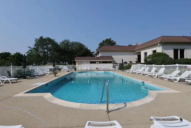 a swimming pool with outdoor seating and yard