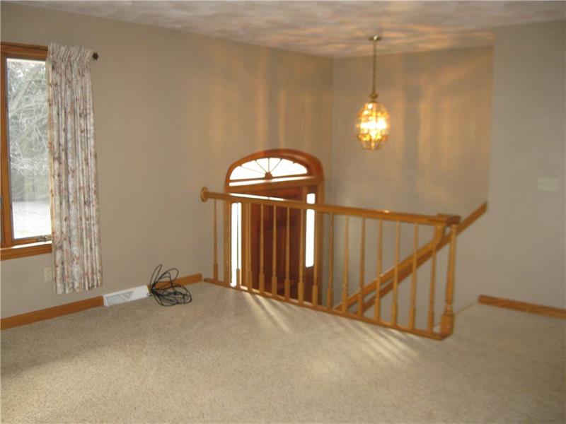 628 Unionville Road Butler, PA 16001 - Photo 14 of 21 Main floor living room leading down to front door. Extrawide inside front entry.