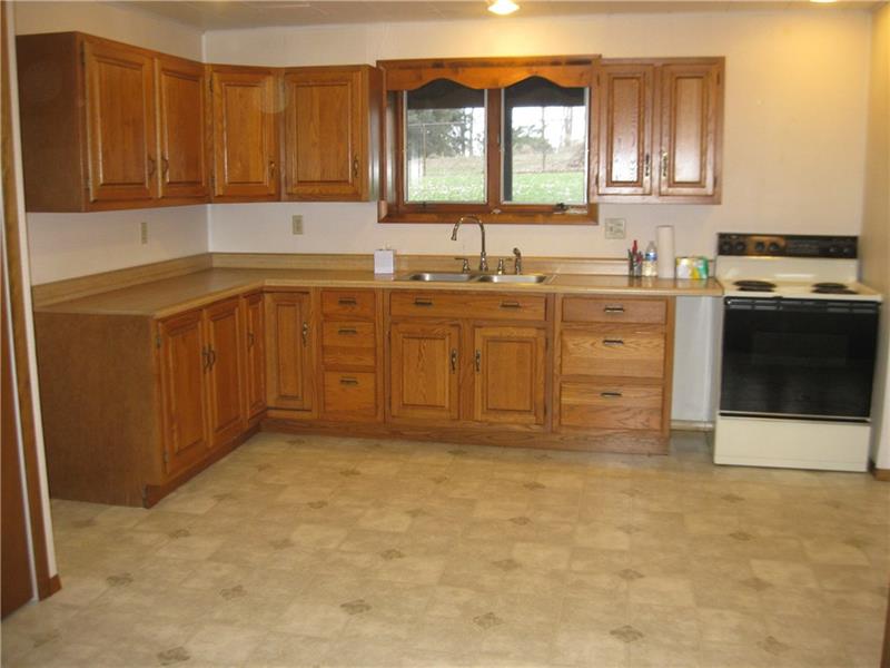 628 Unionville Road Butler, PA 16001 - Photo 3 of 21 Lower level full eat in kitchen. Door going out to the partially fenced in backyard. Another door leads to the attached two car garage. This lower level includes large family room with wood burner, 2 bedrooms with closets, full bath, large laundry room, extra storage closet.