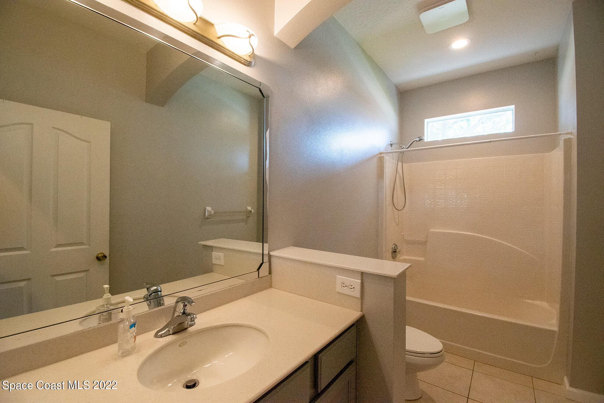 4165 Alamanda Key Drive Melbourne, FL 32901 - Photo 24 of 38 a bathroom with a sink toilet vanity and shower
