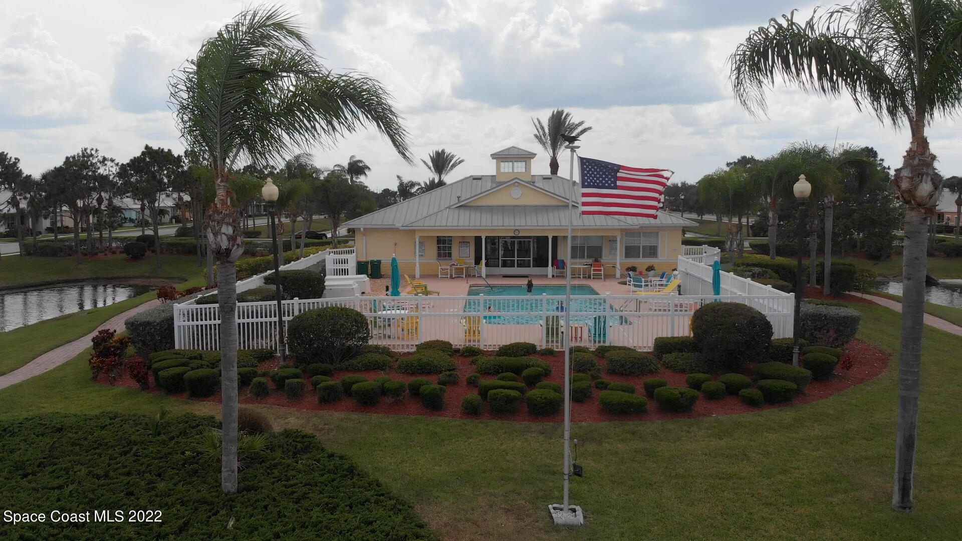 4165 Alamanda Key Drive Melbourne, FL 32901 - Photo 36 of 38 a front view of a house with a garden and lake view