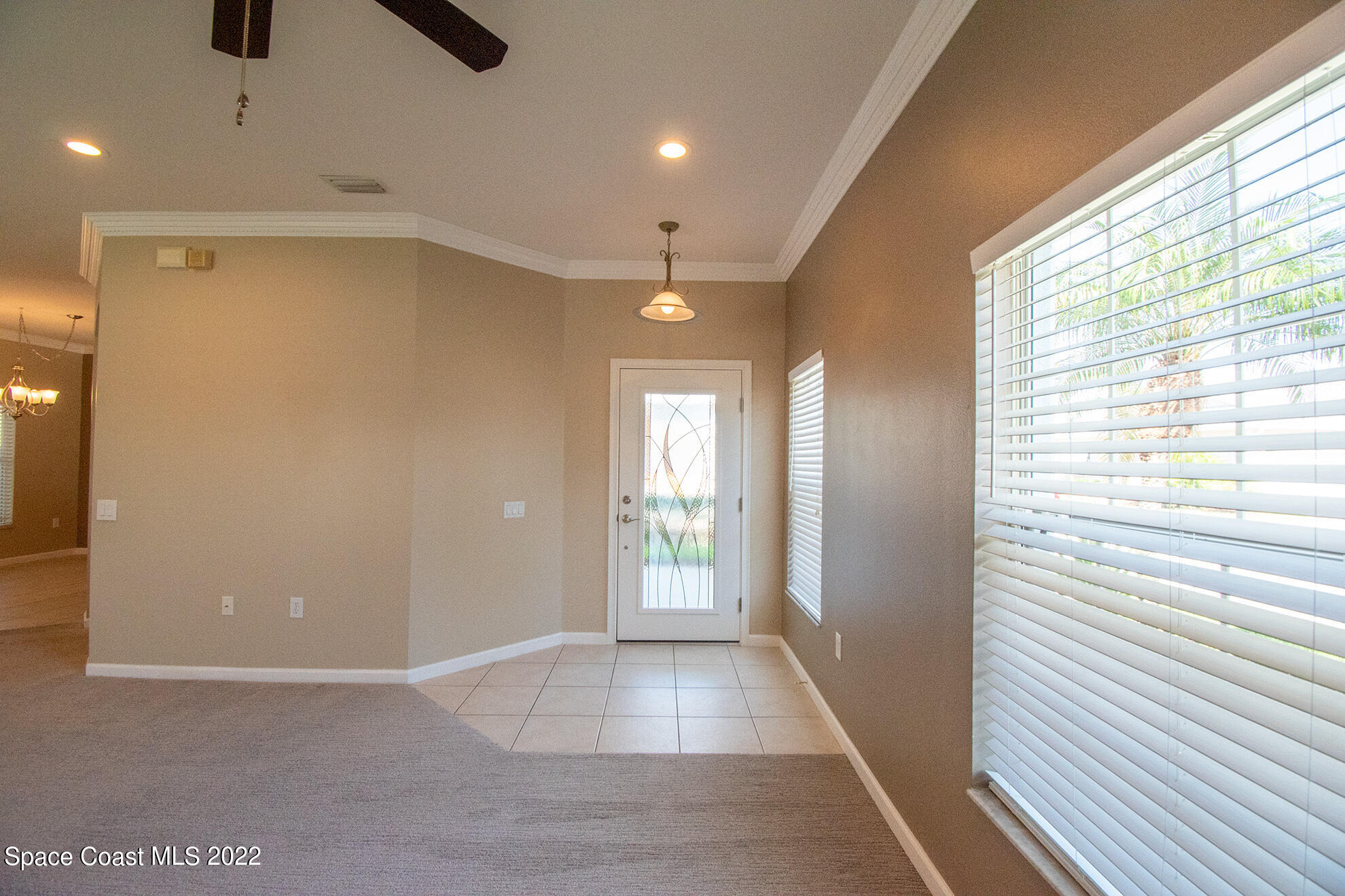 4165 Alamanda Key Drive Melbourne, FL 32901 - Photo 8 of 38 a view of entryway with a window and a ceiling fan