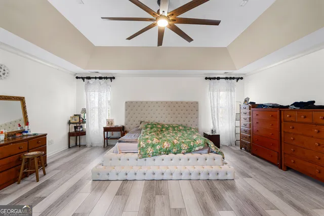 a spacious bathroom with double vanity a large mirror a vanity and a shower