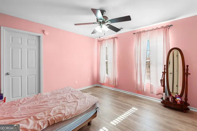 a bedroom with a bed and a mirror