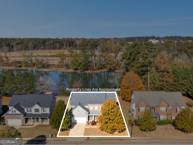an aerial view of a house with lake view