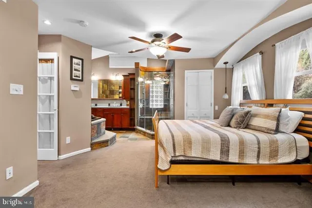 a bedroom with a bed and ceiling fan