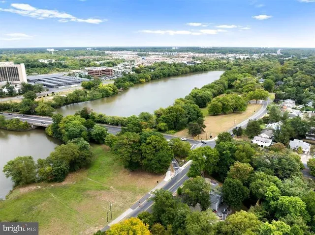 an aerial view of a residential houses with outdoor space and lake view