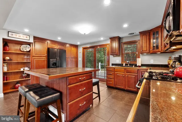 a kitchen with stainless steel appliances granite countertop a stove and a sink