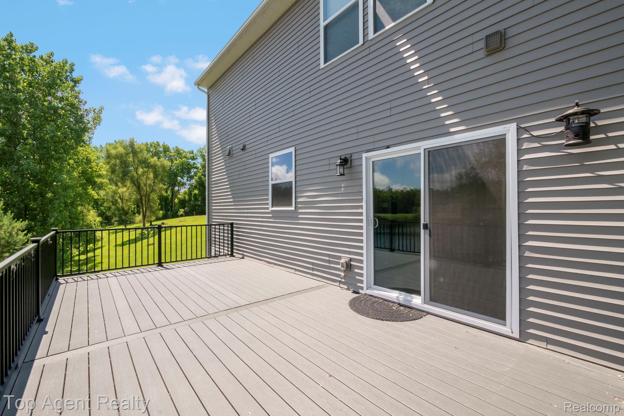 63770 Dequindre Road Washington, MI 48095 - Photo 24 of 61 Expansive composite deck featuring black metal railing