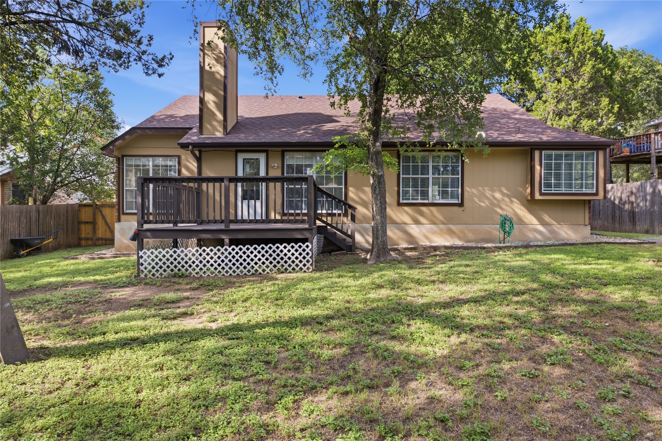 2922 Wickersham Lane Austin, TX 78741 - Photo 16 of 26 a front view of a house with a garden and trees