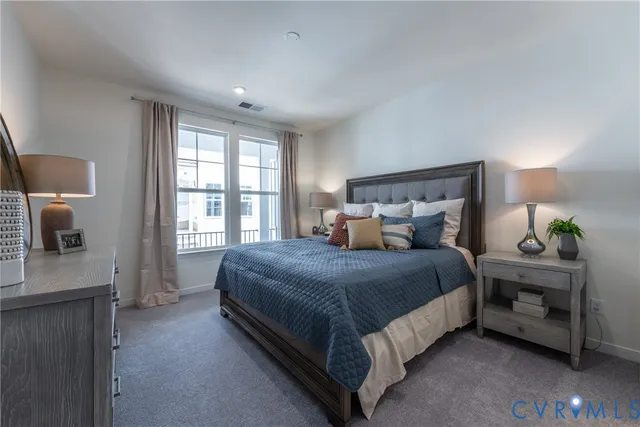 a spacious bedroom with a bed and a window