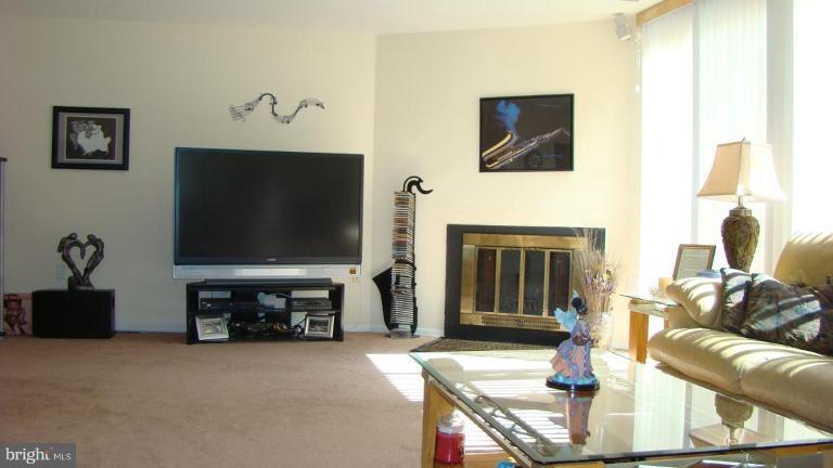 11603 Windbluff Court Reston, VA 20191 - Photo 12 of 22 a living room with furniture a flat screen tv and a fireplace