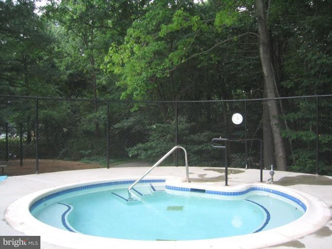 11603 Windbluff Court Reston, VA 20191 - Photo 16 of 22 a view of a swimming pool with a yard