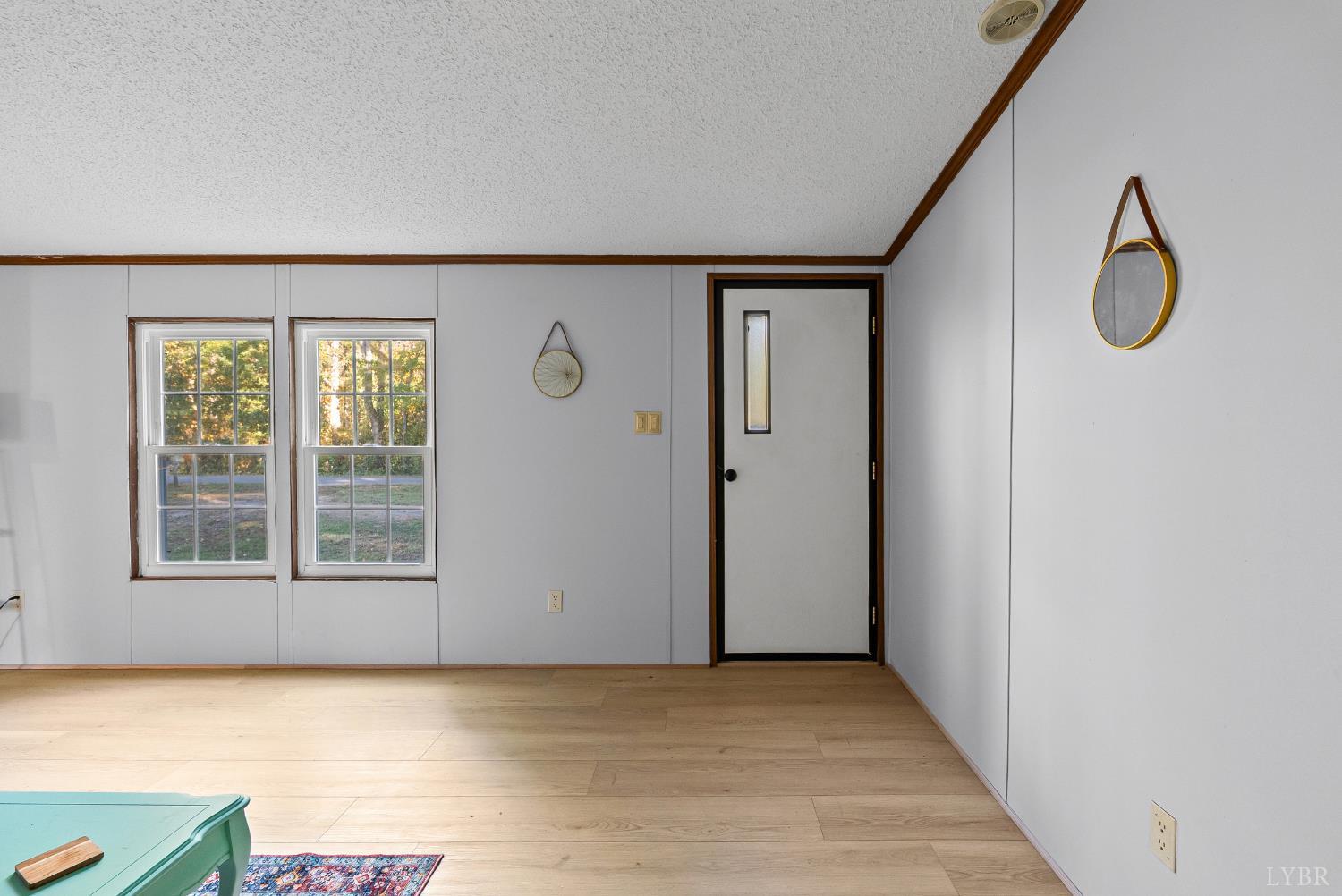 2213 Rabat Road Nathalie, VA 24577 - Photo 11 of 40 a view of an empty room with a window and wooden floor