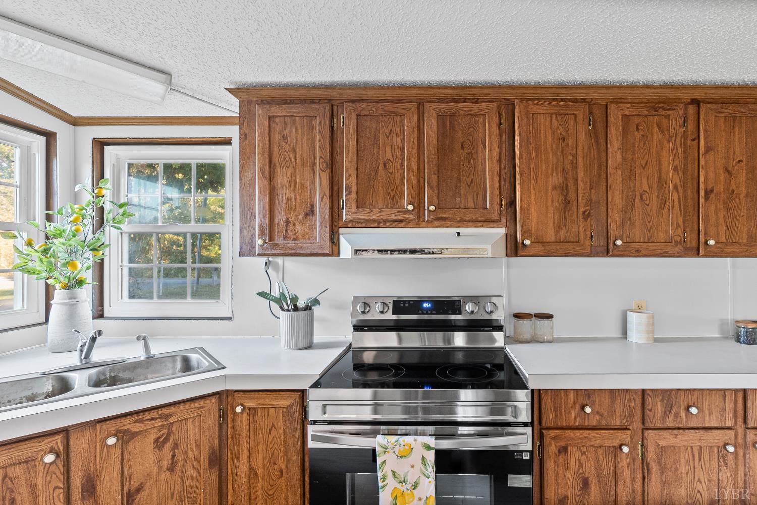 2213 Rabat Road Nathalie, VA 24577 - Photo 14 of 40 a kitchen with granite countertop a stove a sink dishwasher and cabinets with wooden floor