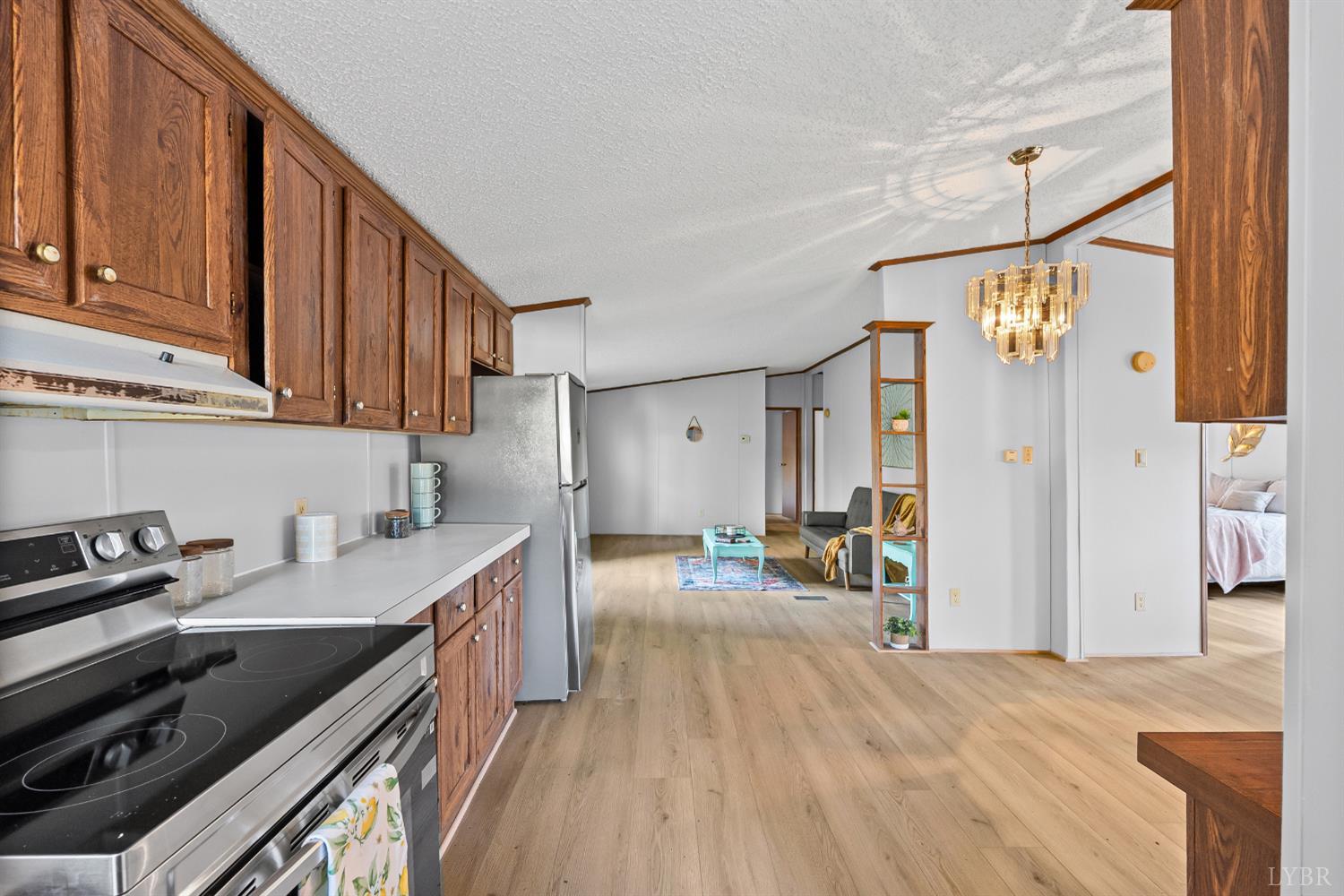 2213 Rabat Road Nathalie, VA 24577 - Photo 16 of 40 a kitchen with granite countertop a sink stove and cabinets