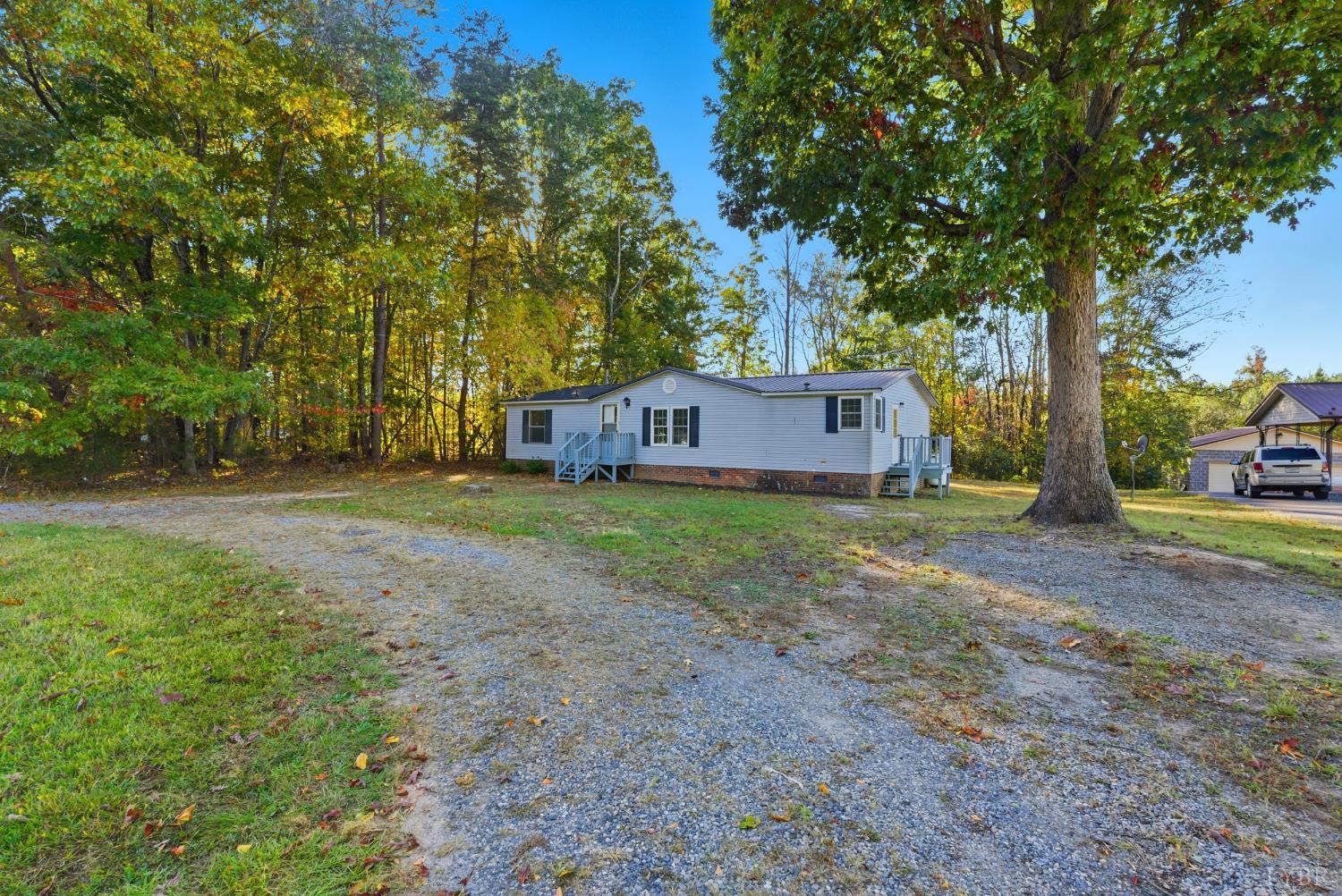 2213 Rabat Road Nathalie, VA 24577 - Photo 27 of 40 a view of a house with a yard and large trees