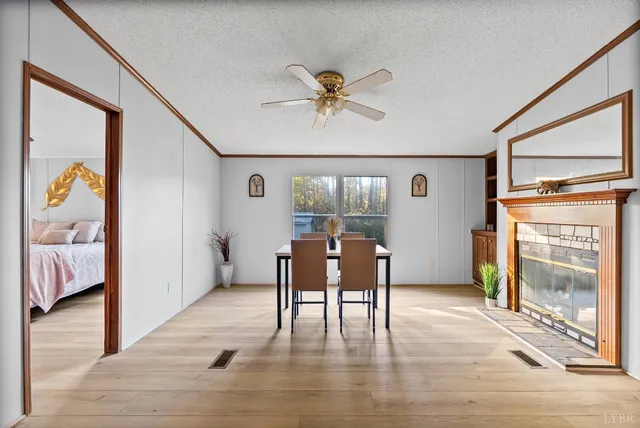 a view of a livingroom with furniture a ceiling fan and wooden floor