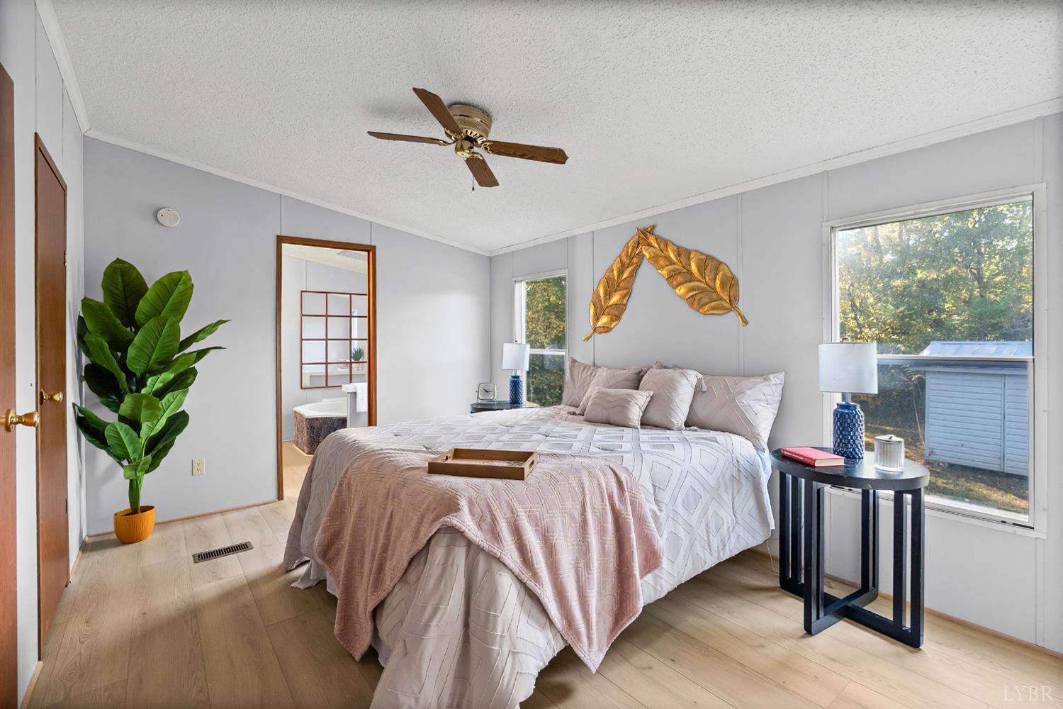 2213 Rabat Road Nathalie, VA 24577 - Photo 5 of 40 a bedroom with a bed and a potted plant