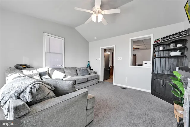 a living room with furniture a lamp and a chandelier
