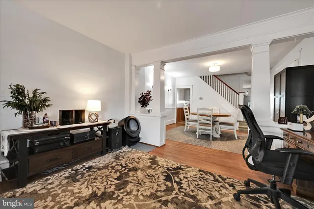 a living room with furniture and wooden floor
