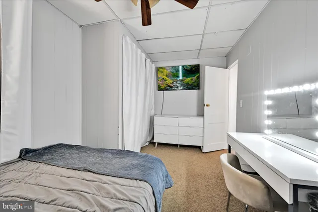 a bedroom with a bed and a couch