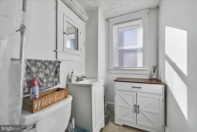 a bathroom with a sink stove and a mirror