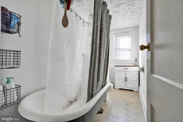 a bathroom with a tub and shower