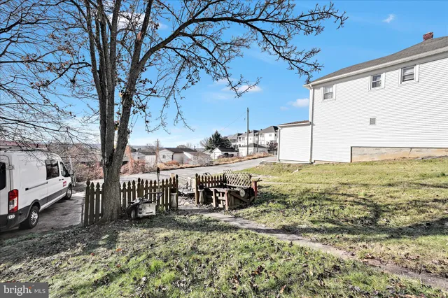 a view of a patio with table and chairs and floor to ceiling window