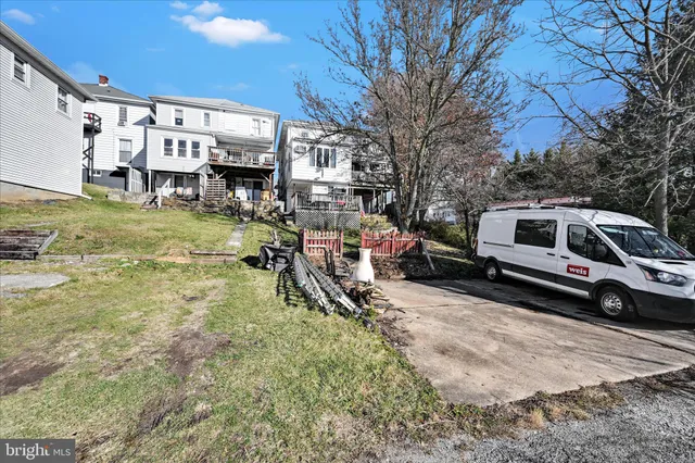 a view of a house with a yard and sitting area